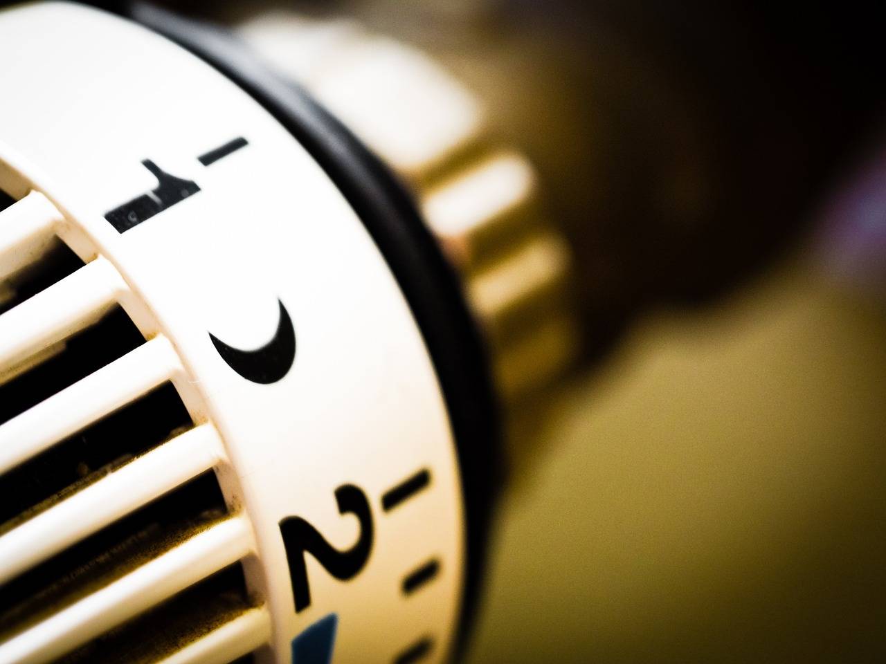 Radiator thermostat used in a home heating system. Close-up of a radiator thermostat dial in a home heating system.