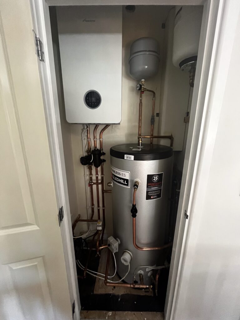 Worcester boiler and Gledhill hot water cylinder installed with copper pipework in a domestic heating system.