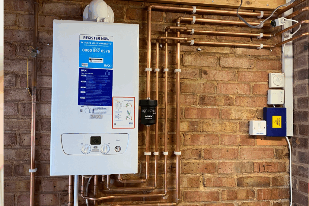 Newly installed boiler with neatly fitted copper pipework in a domestic heating system. installed by Gloucestershire plumber, J. Annear Plumbing & Heating.