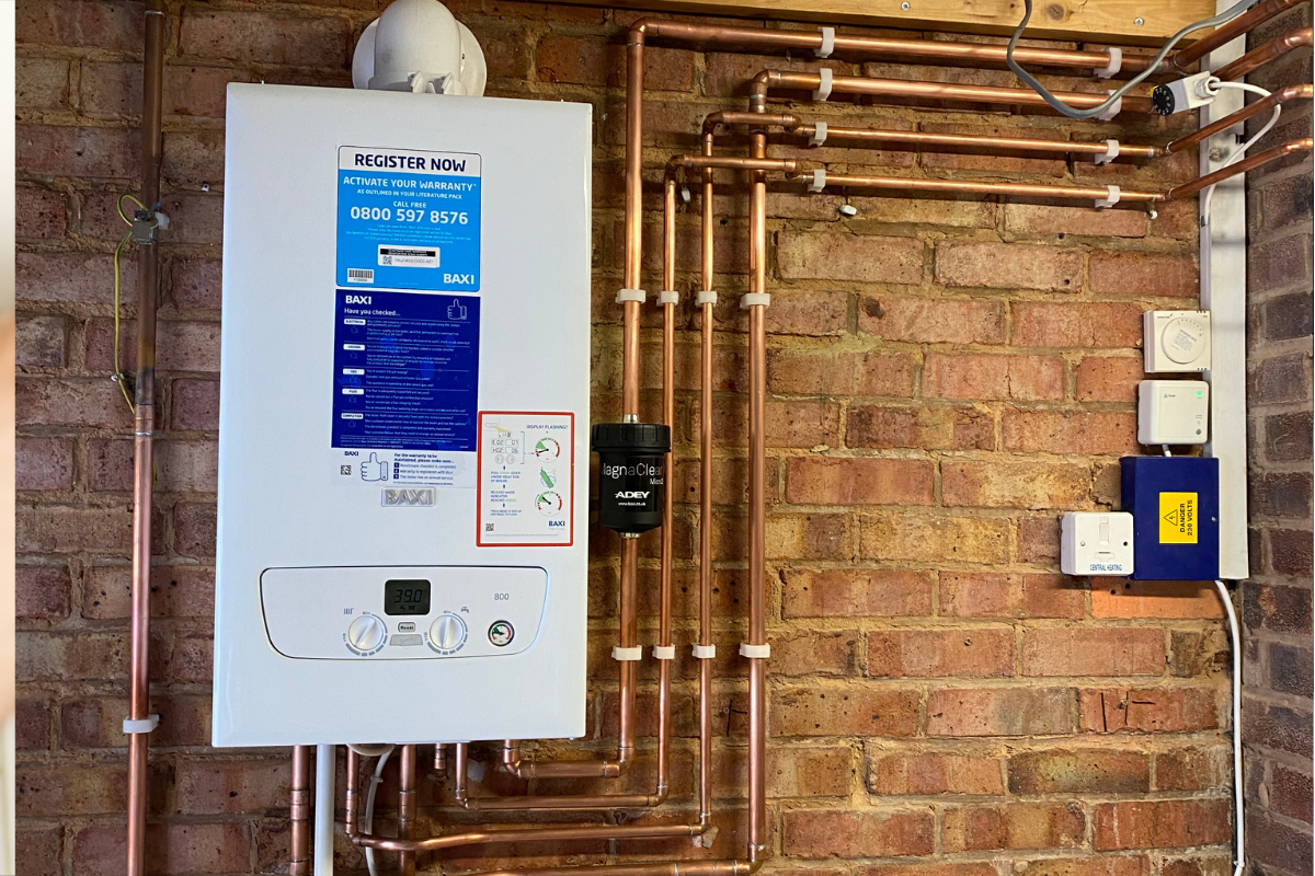 Newly installed boiler with neatly fitted copper pipework in a domestic heating system. installed by Gloucestershire plumber, J. Annear Plumbing & Heating.
