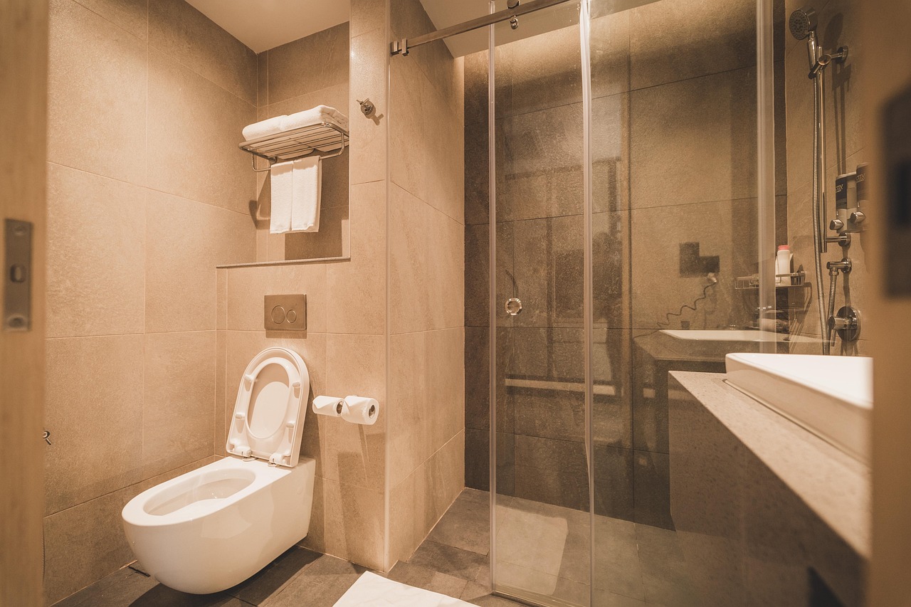 Modern bathroom with walk-in shower and WC, representing bathroom installation services and Gloucestershire plumbing.